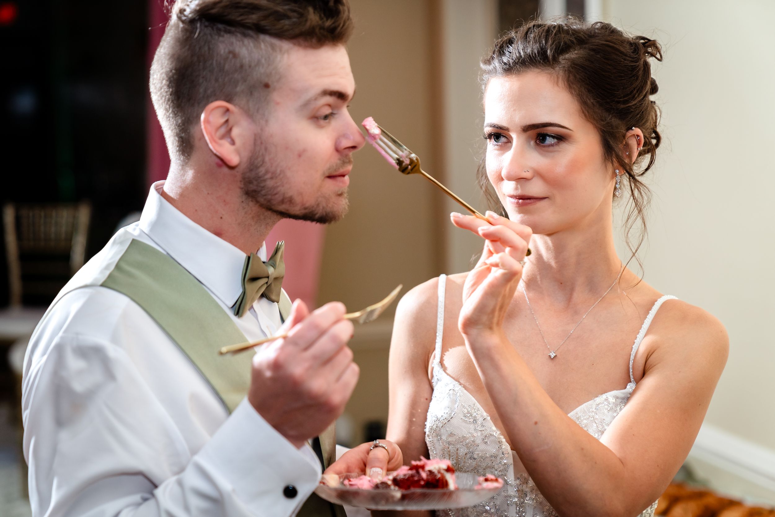 Newlyweds sharing a sweet moment with champagne glasses during their wedding reception.