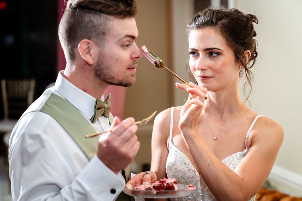 Newlyweds sharing a sweet moment with champagne glasses during their wedding reception.