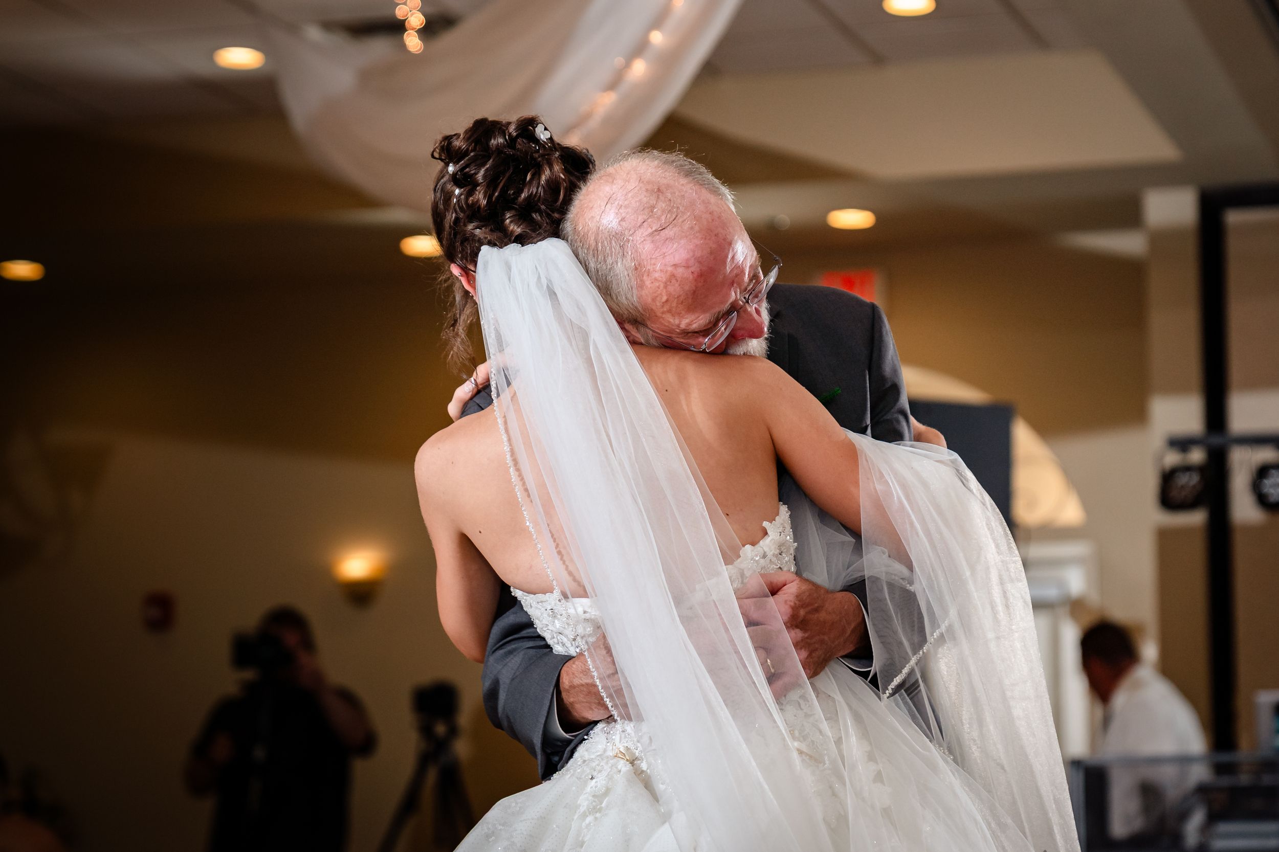 Wedding celebration in an elegant indoor venue with warm lighting and romantic atmosphere.