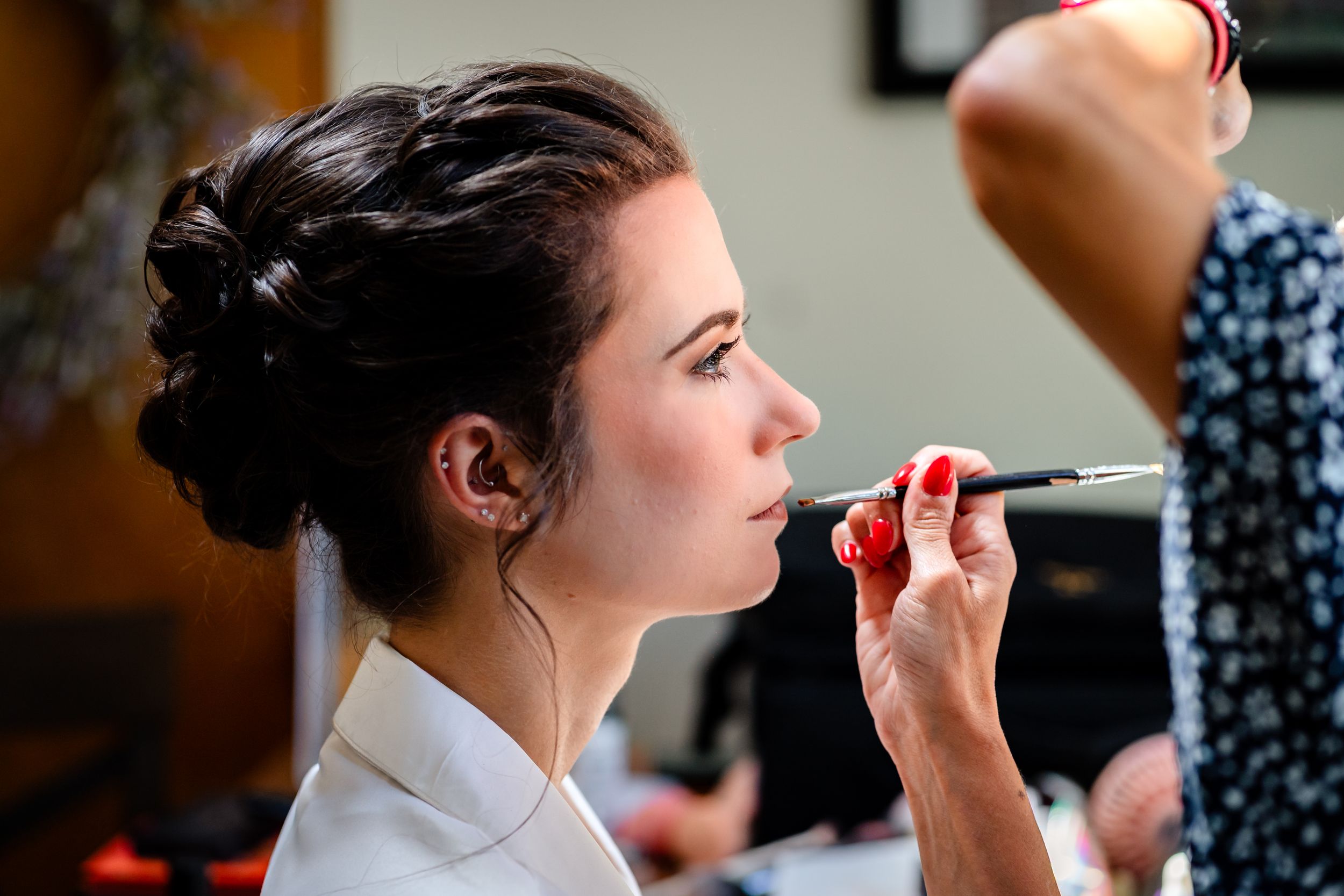 A sequence of photos showing someone applying lipstick and makeup in preparation for a special event.