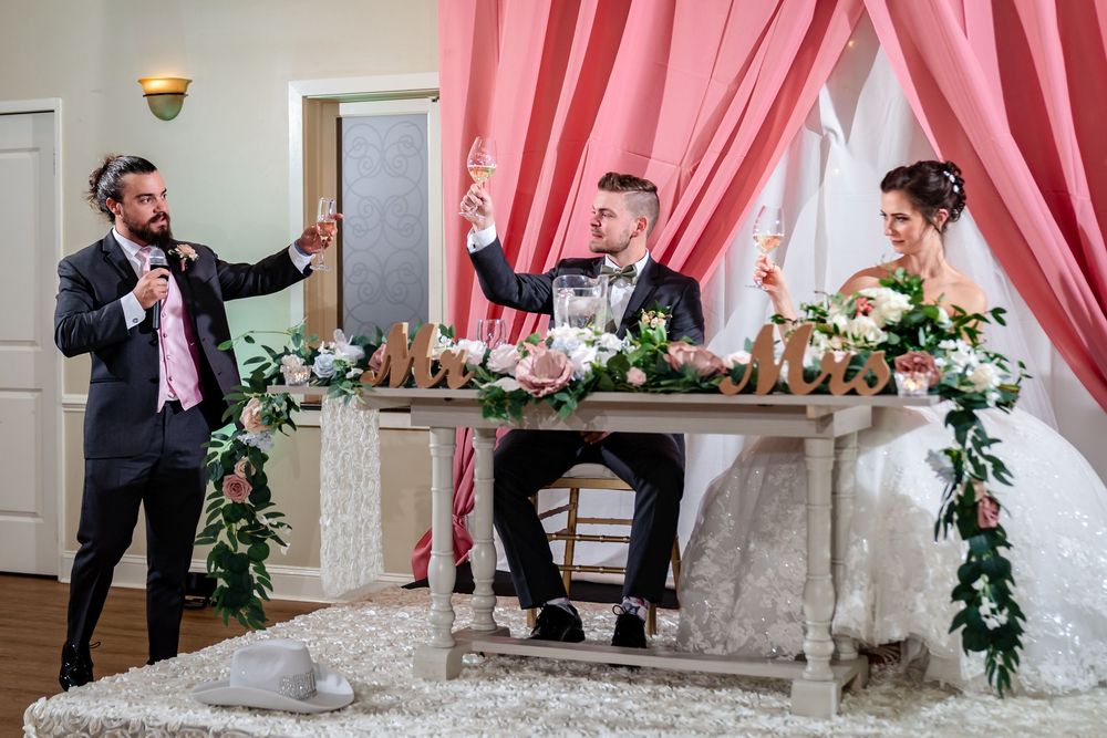 Wedding venue decorated with pink drapes and floral arrangements creating an elegant backdrop.
