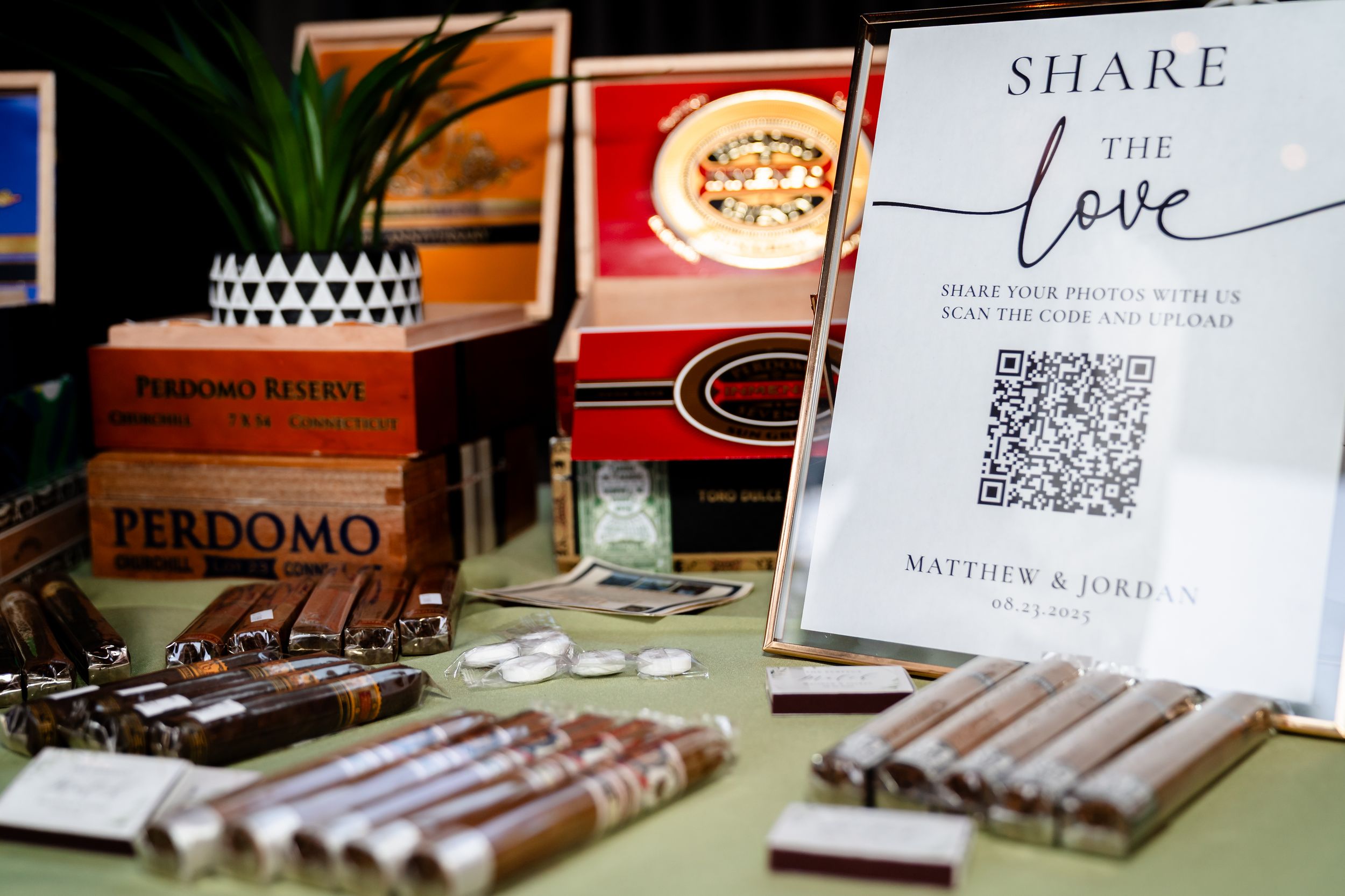 A close-up view of premium cigars arranged in wooden boxes at a luxury cigar shop display.