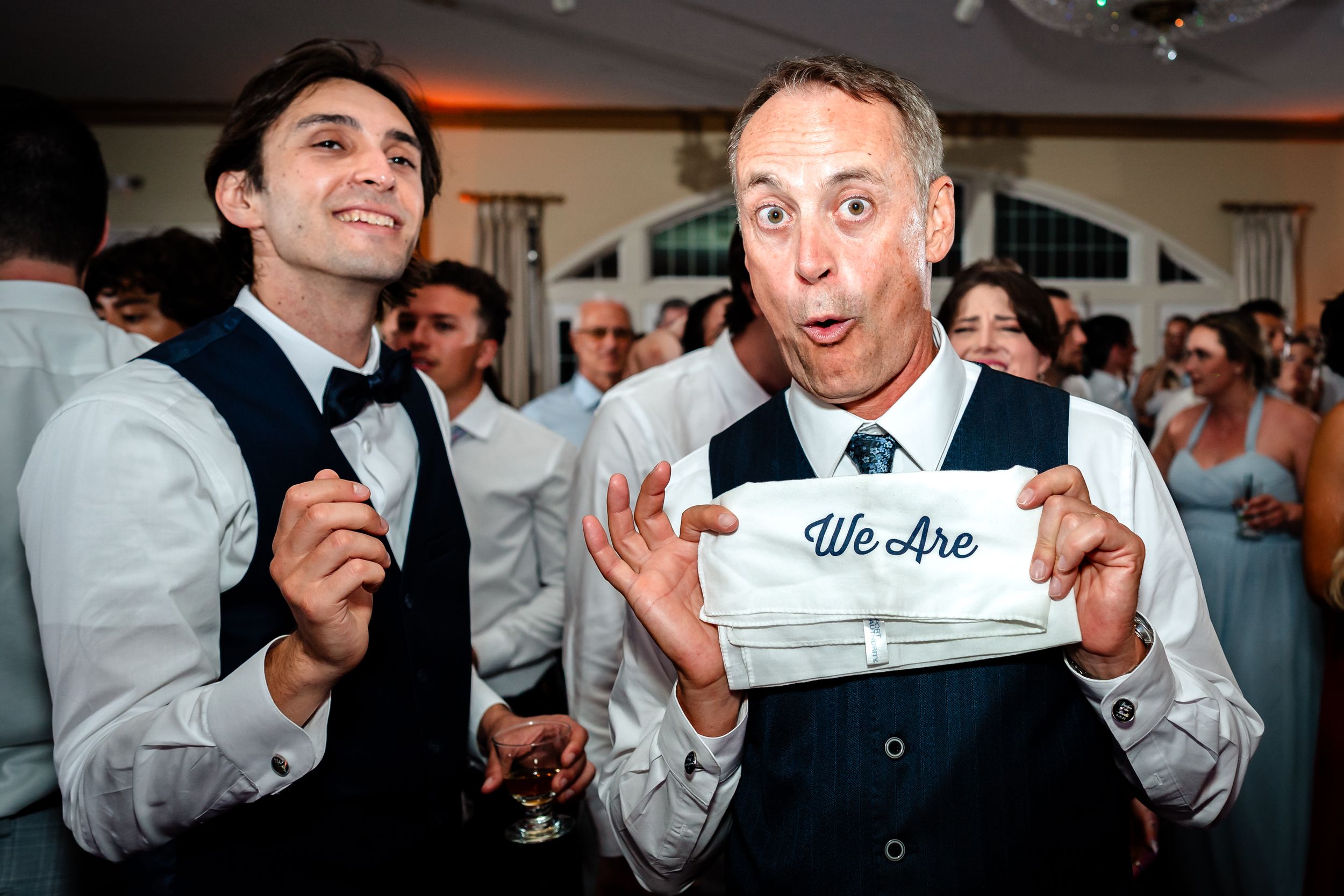 A series of wedding reception photos showing guests making silly faces and holding up signs during a celebration.