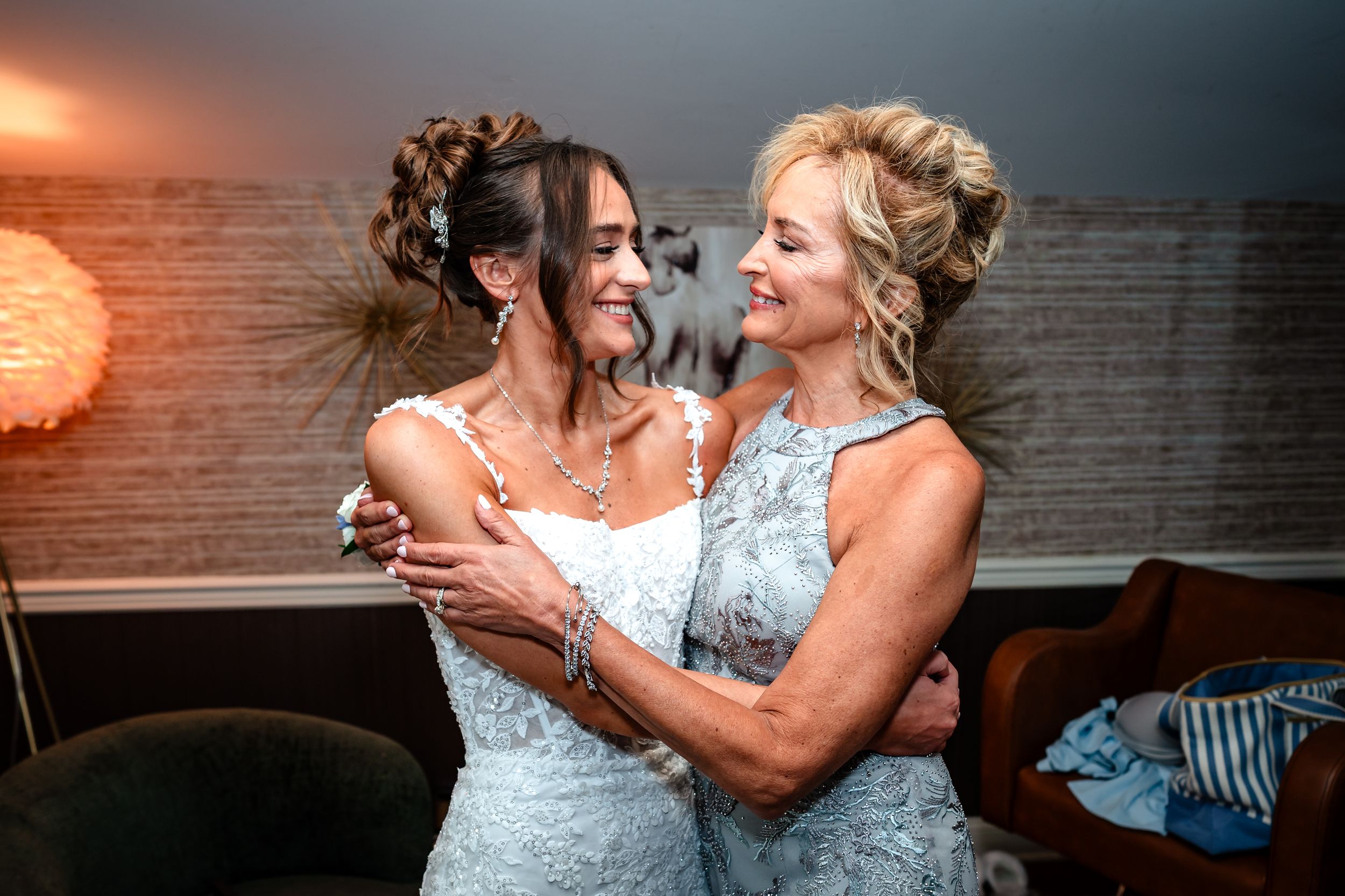 Two people in formal attire share a joyful moment while dancing together at a celebration.