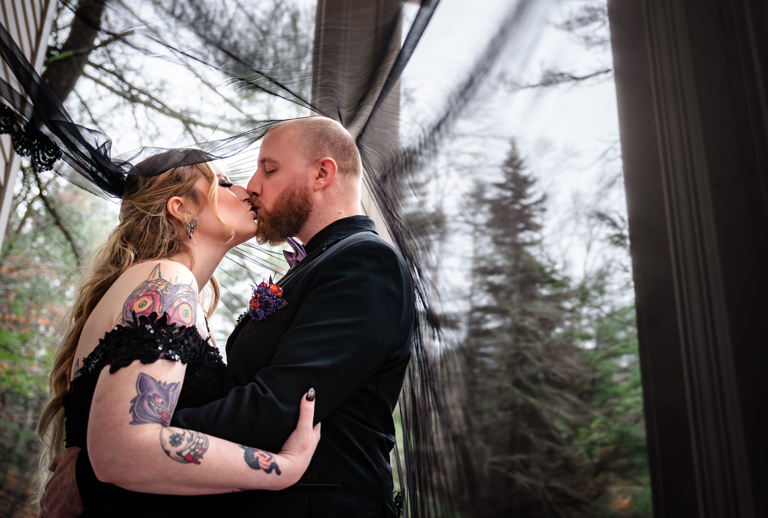 A collection of intimate winter wedding photos captured through wooden pillars with snow-covered trees in background.