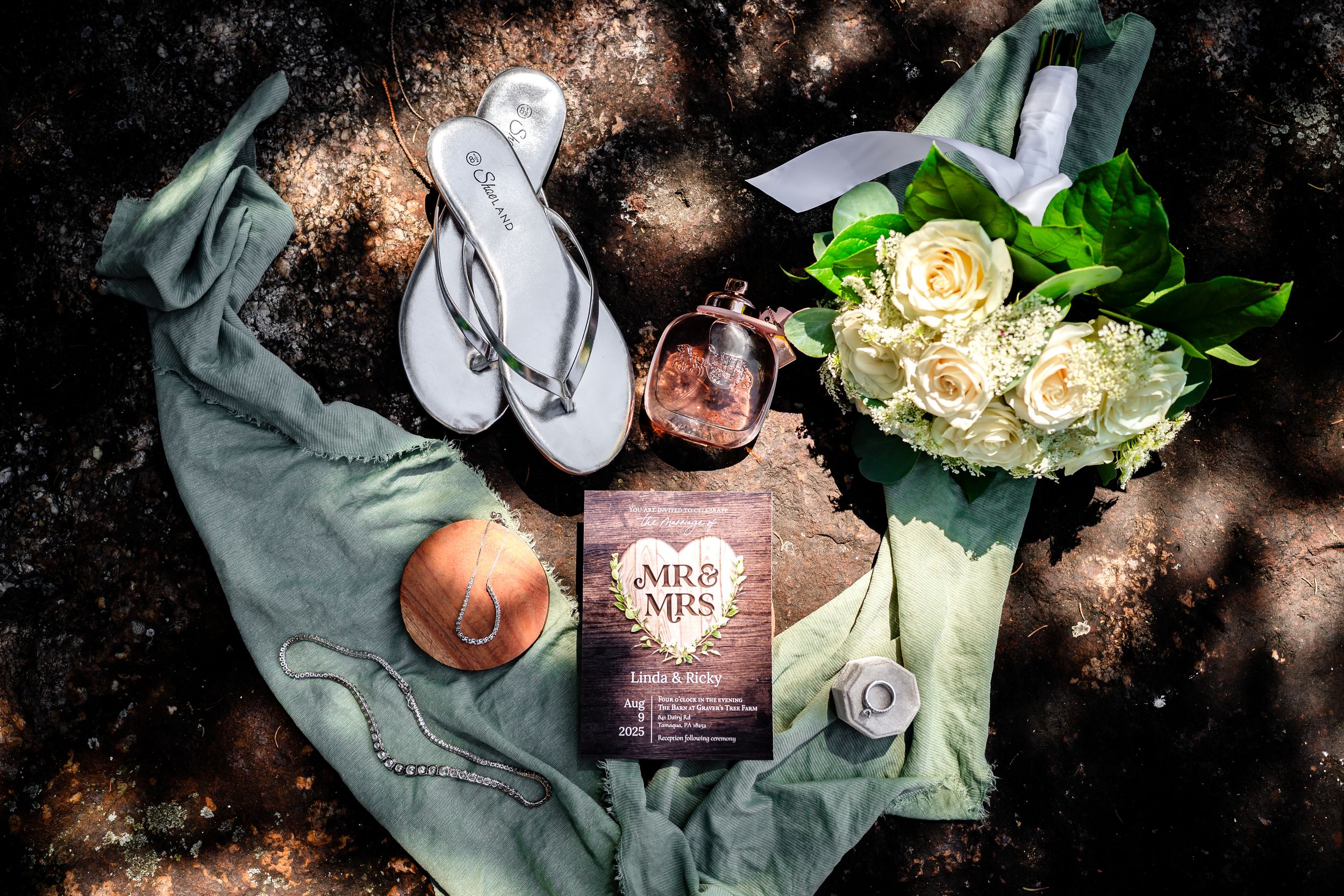 Romantic still life with books, flowers, and vintage decor arranged on dark moody background with soft lighting.