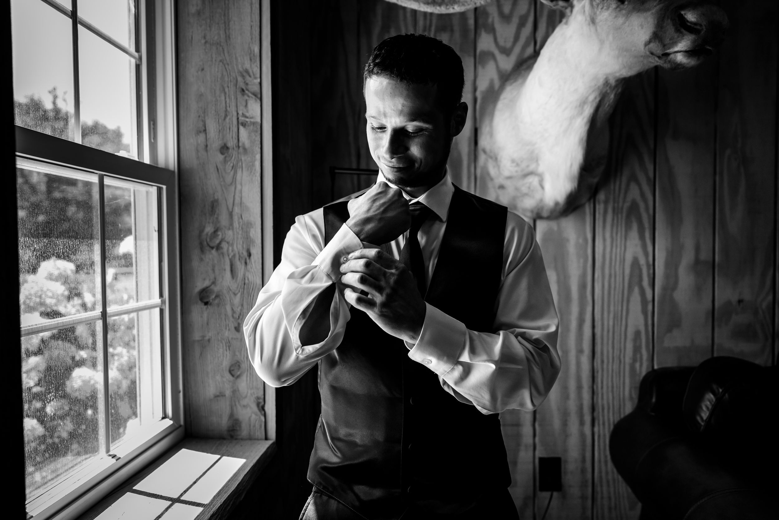 Black and white photo sequence of someone smoking near a window in moody dramatic lighting.