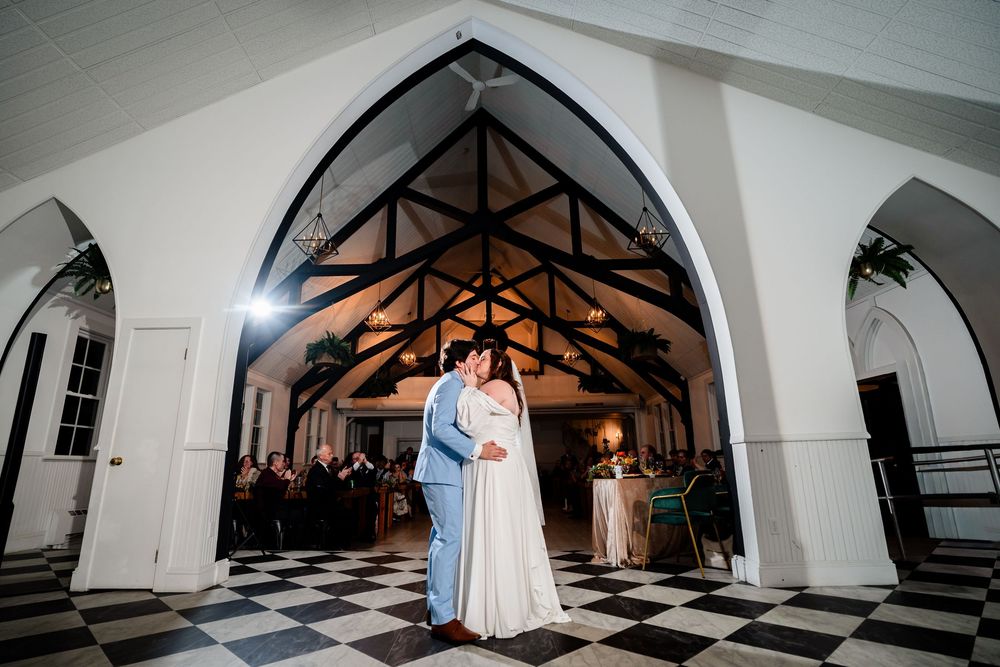 A series of dramatic black and white wedding photos showing a couple dancing in a grand checkered-floor ballroom.