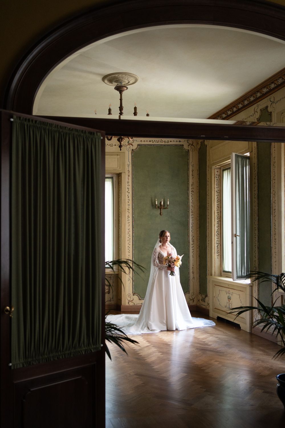 A series of connected interior photos showing a white wedding dress in an elegant room with green curtains and wooden floors.
