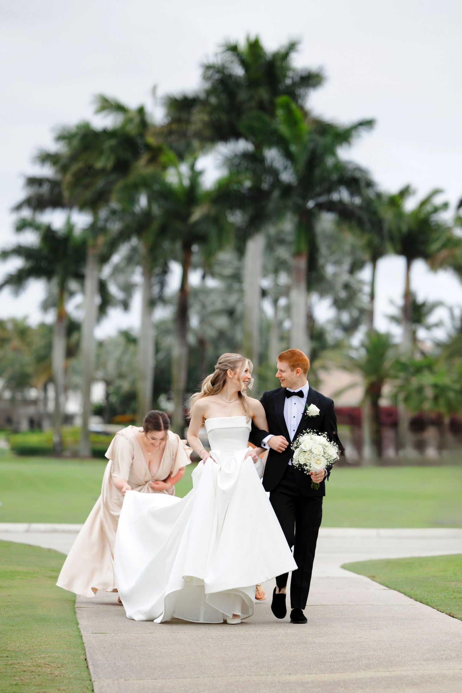 Bride and groom walking outside at BallenIsles Country Club in Palm Beach, Florida during a wedding photographed by Tom Forrest of Ohio.