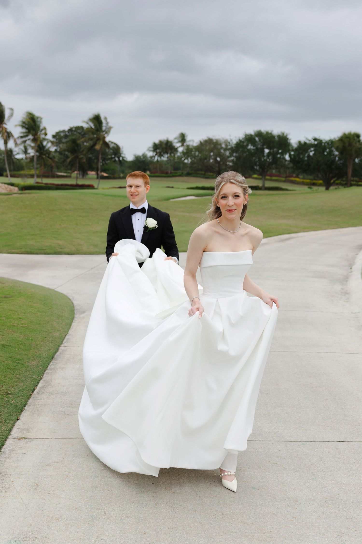 Bride and groom walking at BallenIsles Country Club in Palm Beach, Florida during a wedding photographed by Tom Forrest of Ohio.
