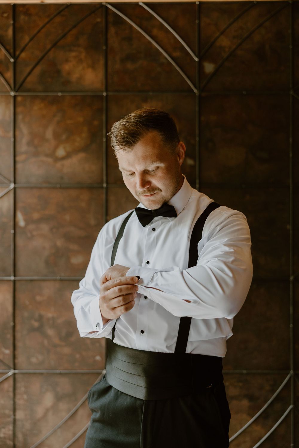 Groom putting on tie at Mill & Mine Knoxville, wedding photography by Allie Krauser Digitals
