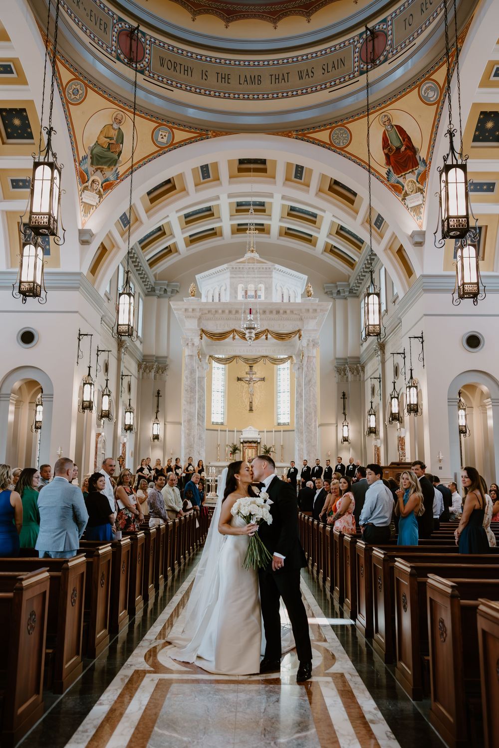 Bride and groom kiss down aisle at Sacred Heart Cathedral Knoxville, Tennessee wedding ceremony
