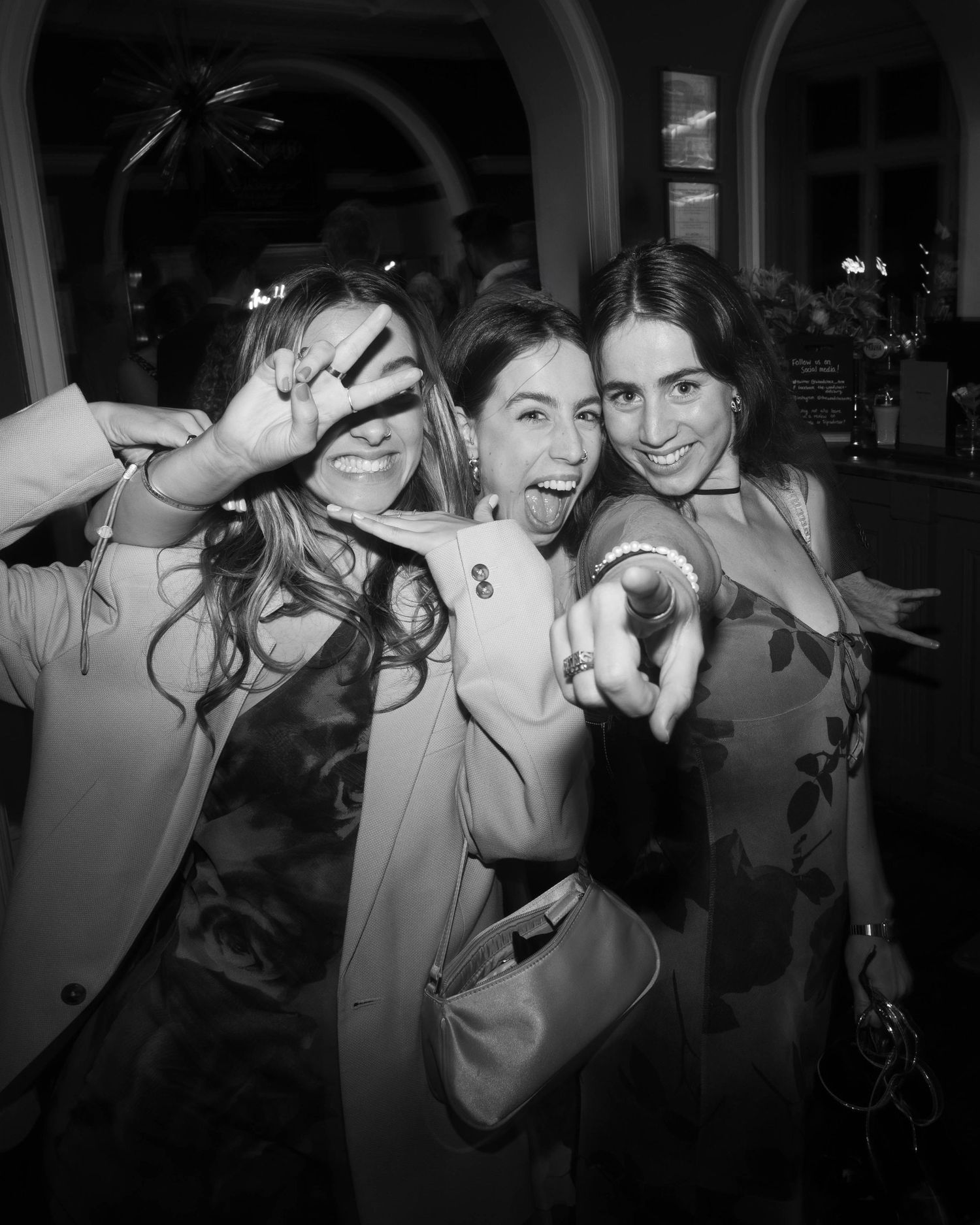 Black and white photo series showing playful expressions and gestures. Flash Photography Wedding Dancefloor