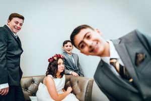 Business colleagues engage in casual conversation and laughter during an office meeting.