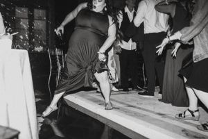 Wedding guests dancing in black and white on an animated dance floor.