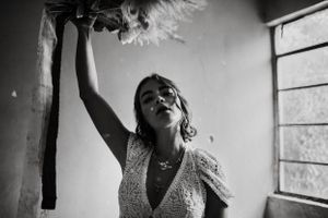 A black and white candid moment capturing joy and movement in a wedding dress.