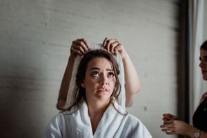 Bride getting ready sequence showing hair and makeup preparation.