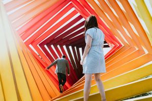 Abstract colorful corridor with geometric patterns in orange and yellow tones.