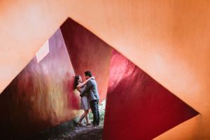 Abstract wedding photography with deep orange and red geometric shadows creating artistic composition.