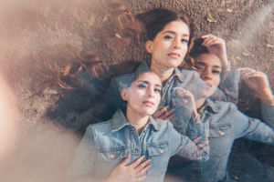 Dreamy portrait through glass with soft focus and warm tones.
