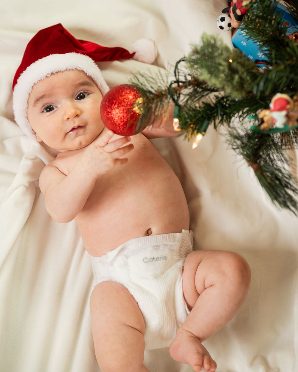 New Jersey baby photographer capturing a smiling baby in a warm studio setting