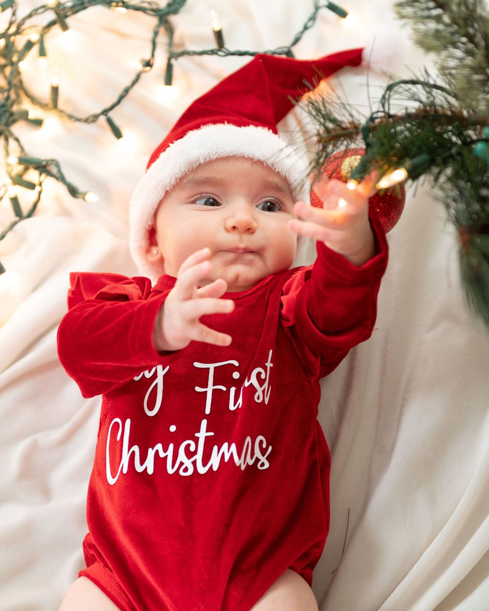 New Jersey baby photographer capturing a smiling baby in a warm studio setting