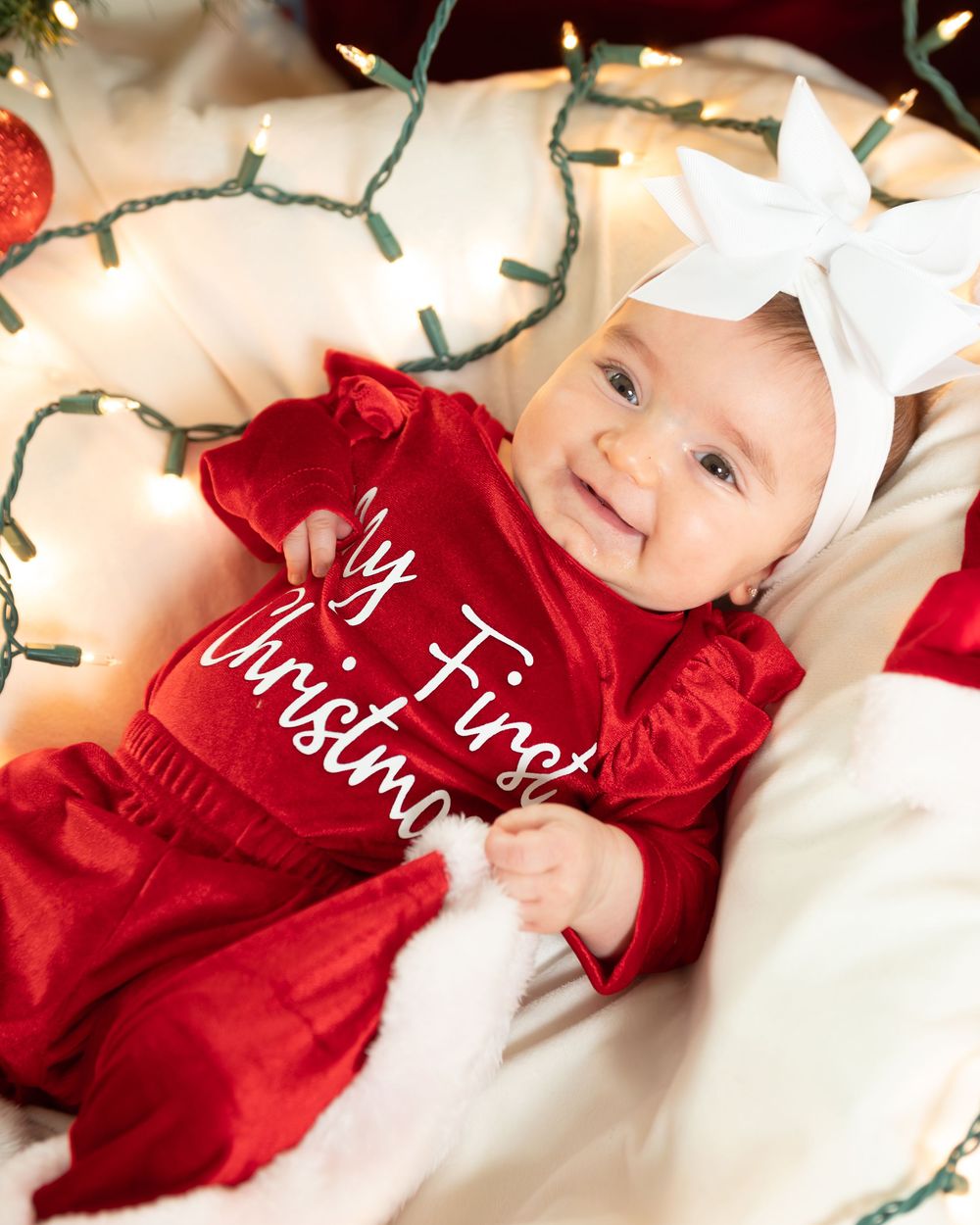 New Jersey baby photographer capturing a smiling baby in a warm studio setting
