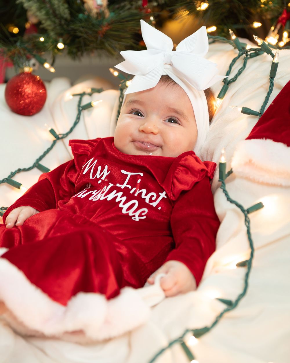 New Jersey baby photographer capturing a smiling baby in a warm studio setting