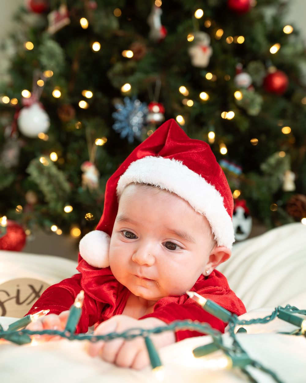 New Jersey baby photographer capturing a smiling baby in a warm studio setting