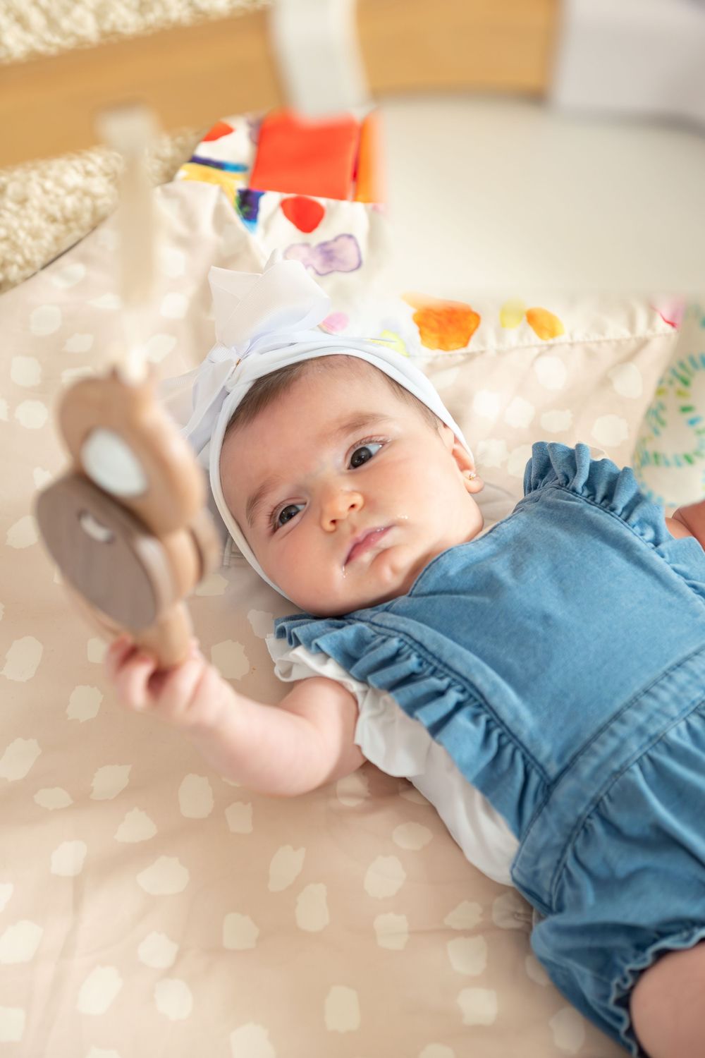 New Jersey baby photographer capturing a smiling baby in a warm studio setting