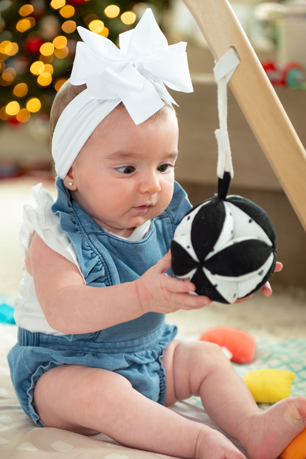 New Jersey baby photographer capturing a smiling baby in a warm studio setting