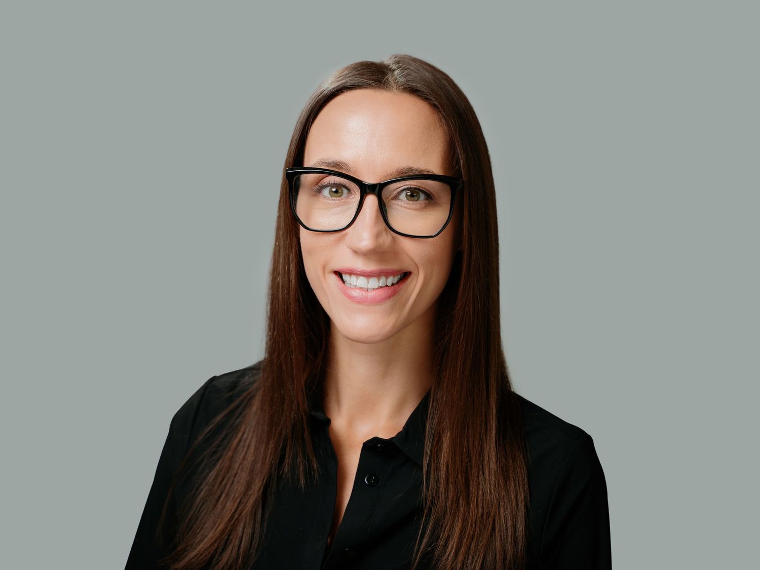 Professional headshots of someone with long brown hair and glasses against a gray background in various poses.