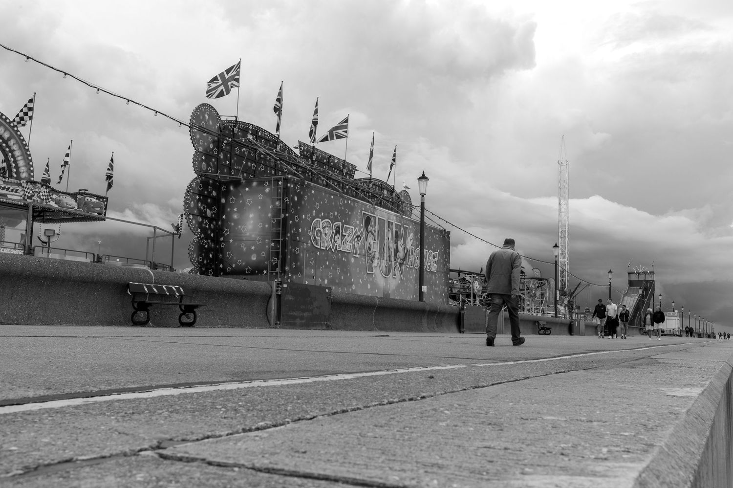 Black and white panoramic sequence showing a vintage aircraft taking off from an airfield in dramatic weather conditions.