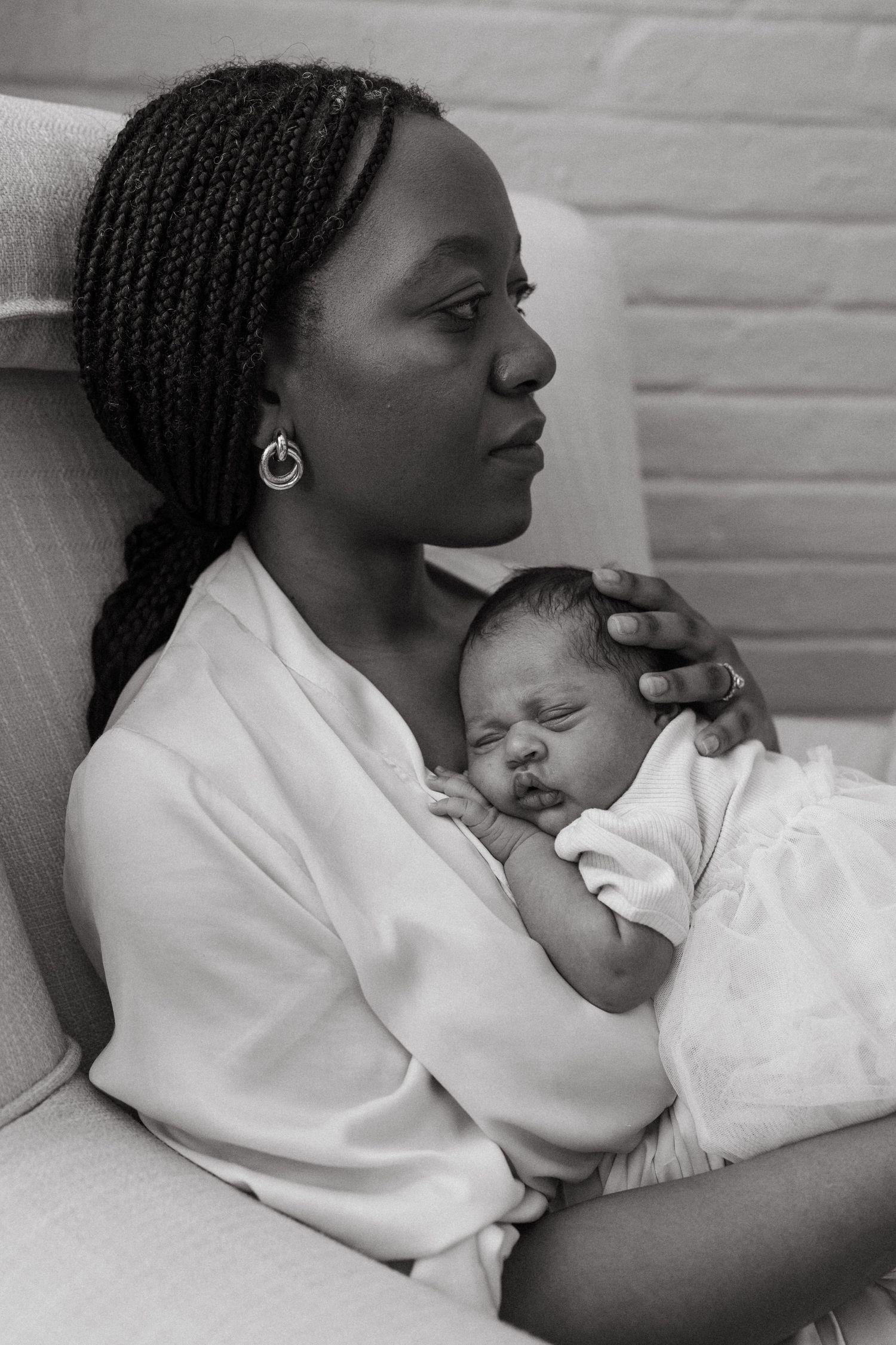 A tender black and white photo series showing intimate breastfeeding moments between mother and newborn.