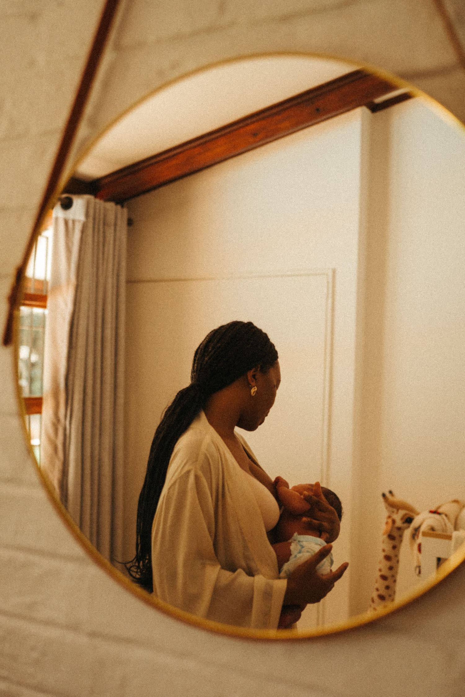 A sequence of mirror reflections showing nurturing moments between parent and baby.