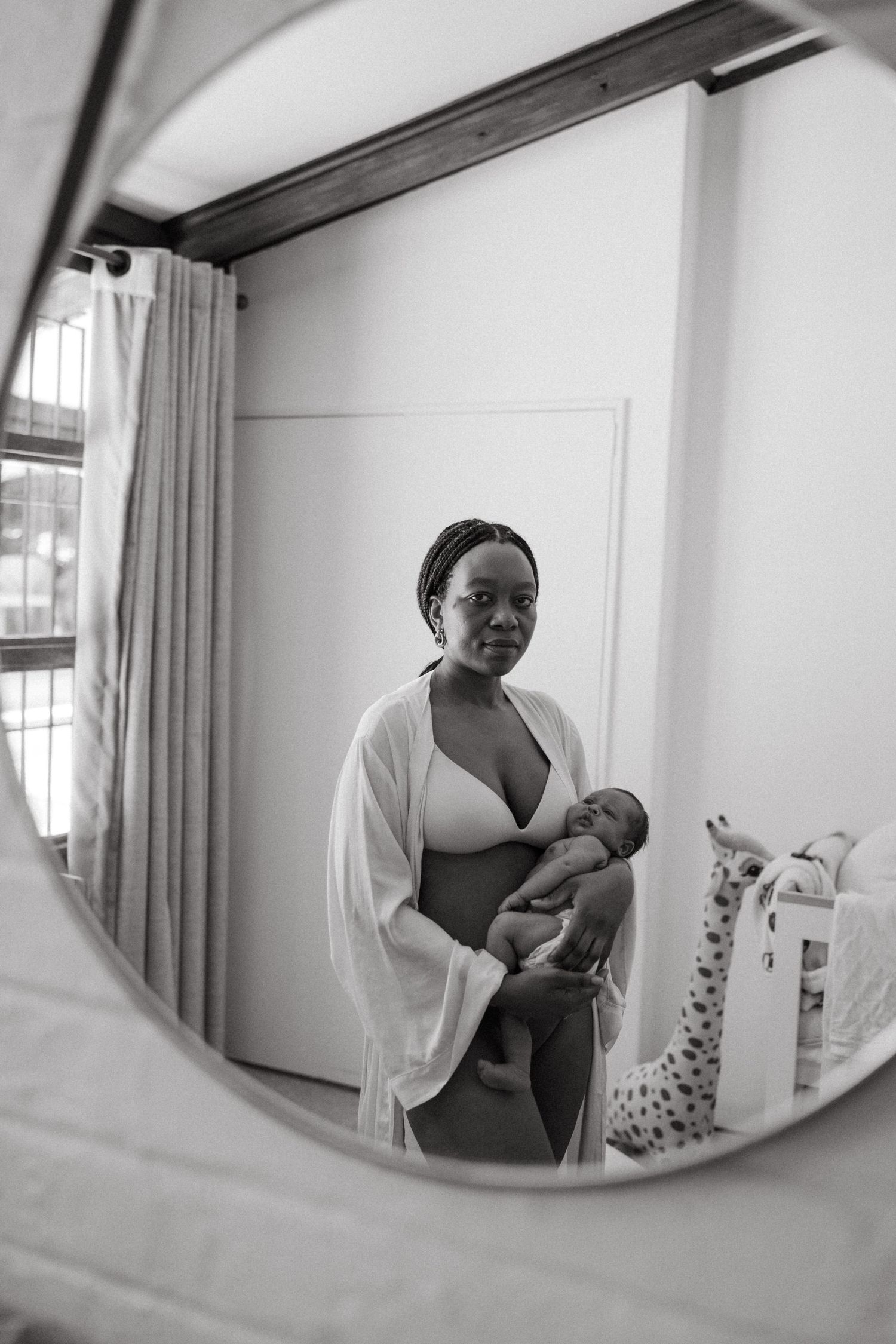 A series of oval mirror reflections capturing intimate parenting moments.