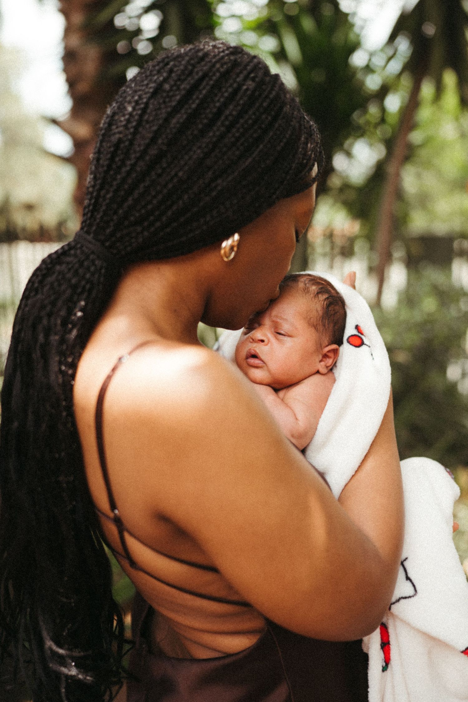 Outdoor photography sequence showing tender moments between mother and infant in natural lighting.