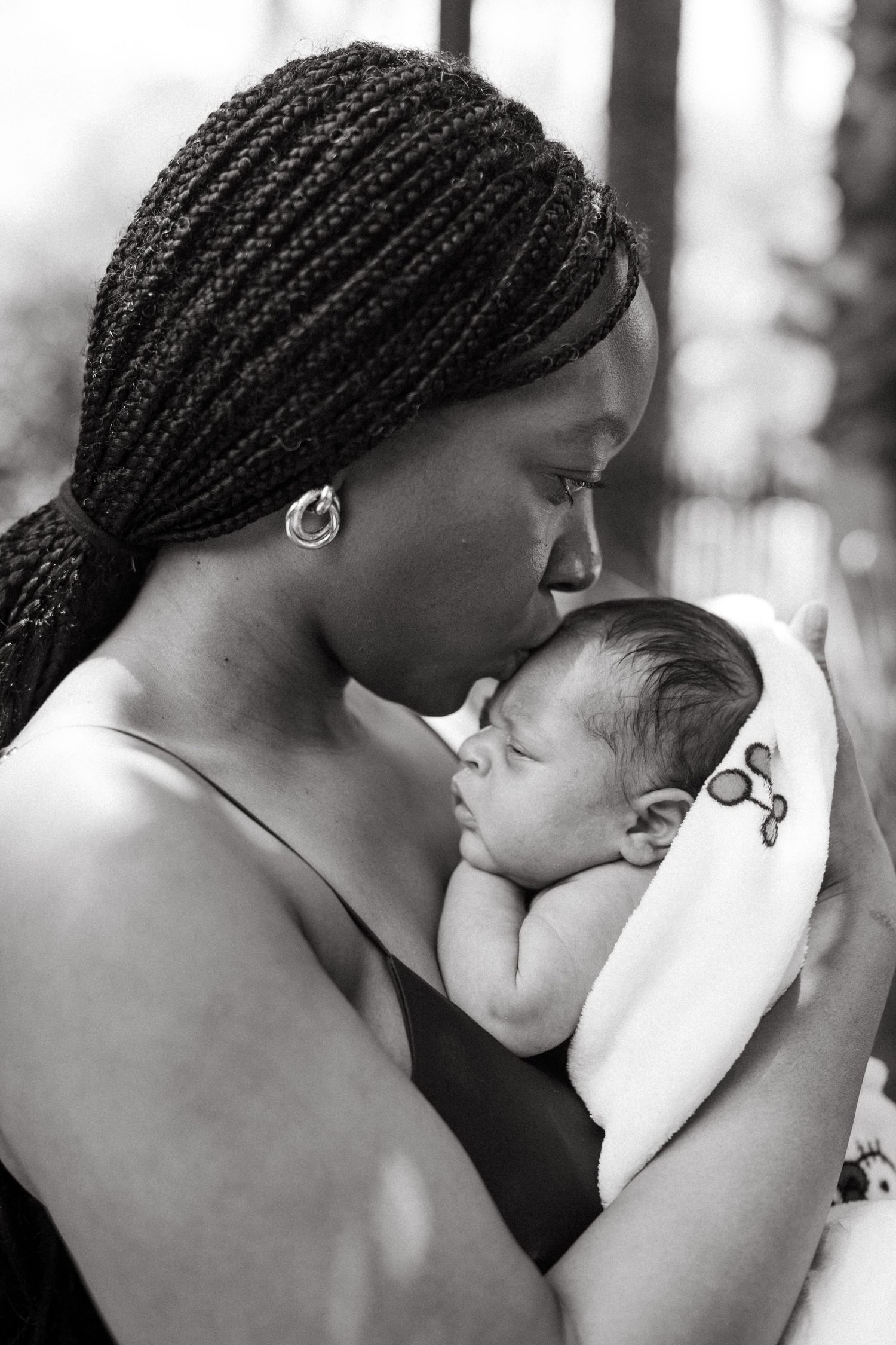 Artistic black and white portraits capturing intimate bonding moments between parent and child.