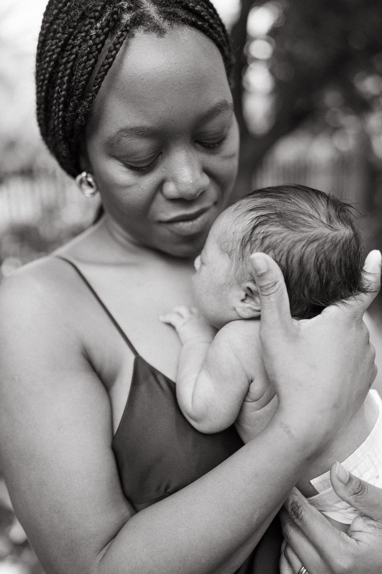 Black and white photo series capturing gentle moments between mother and baby.