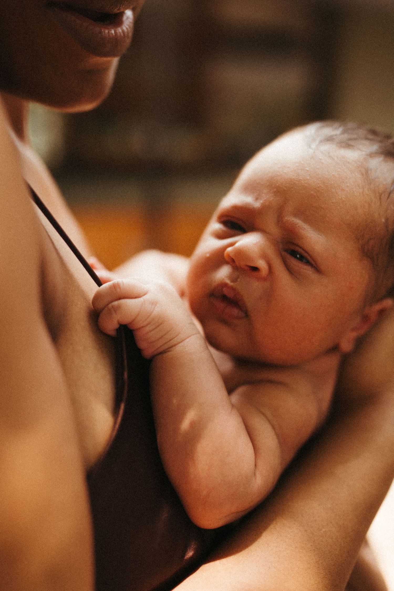 Close-up sequence showing tender moments between parent and infant.