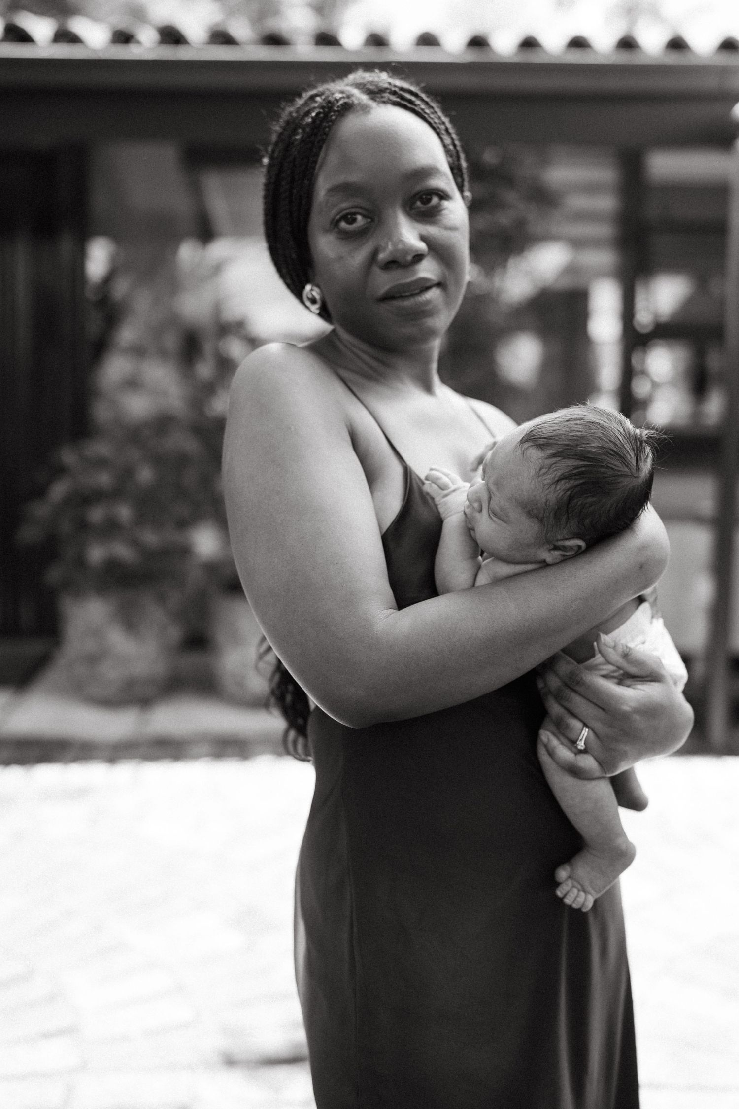 Black and white series showing joyful moments between mother and baby outdoors.