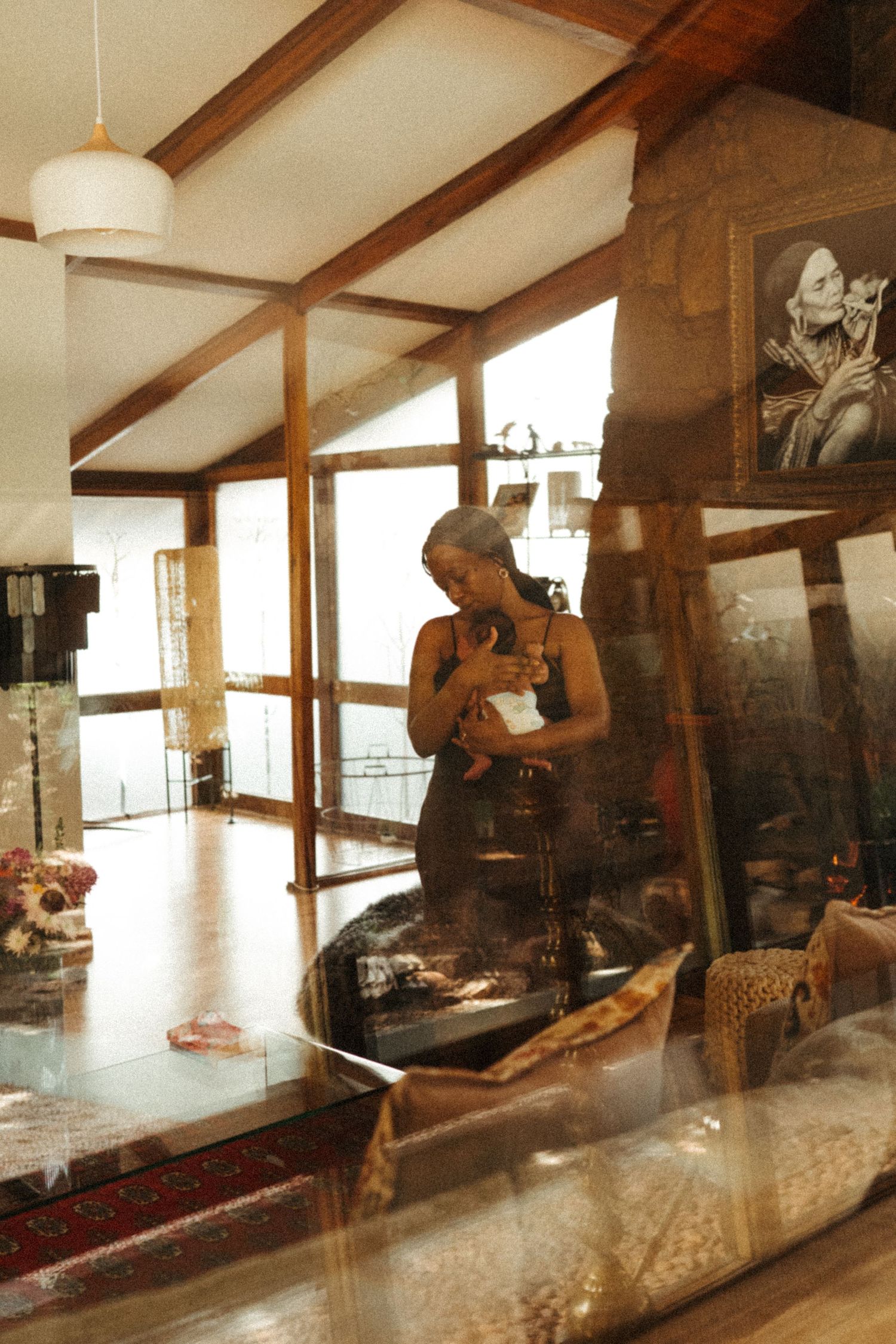 Sepia-toned sequence showing person playing cello in spacious room with wooden beams.