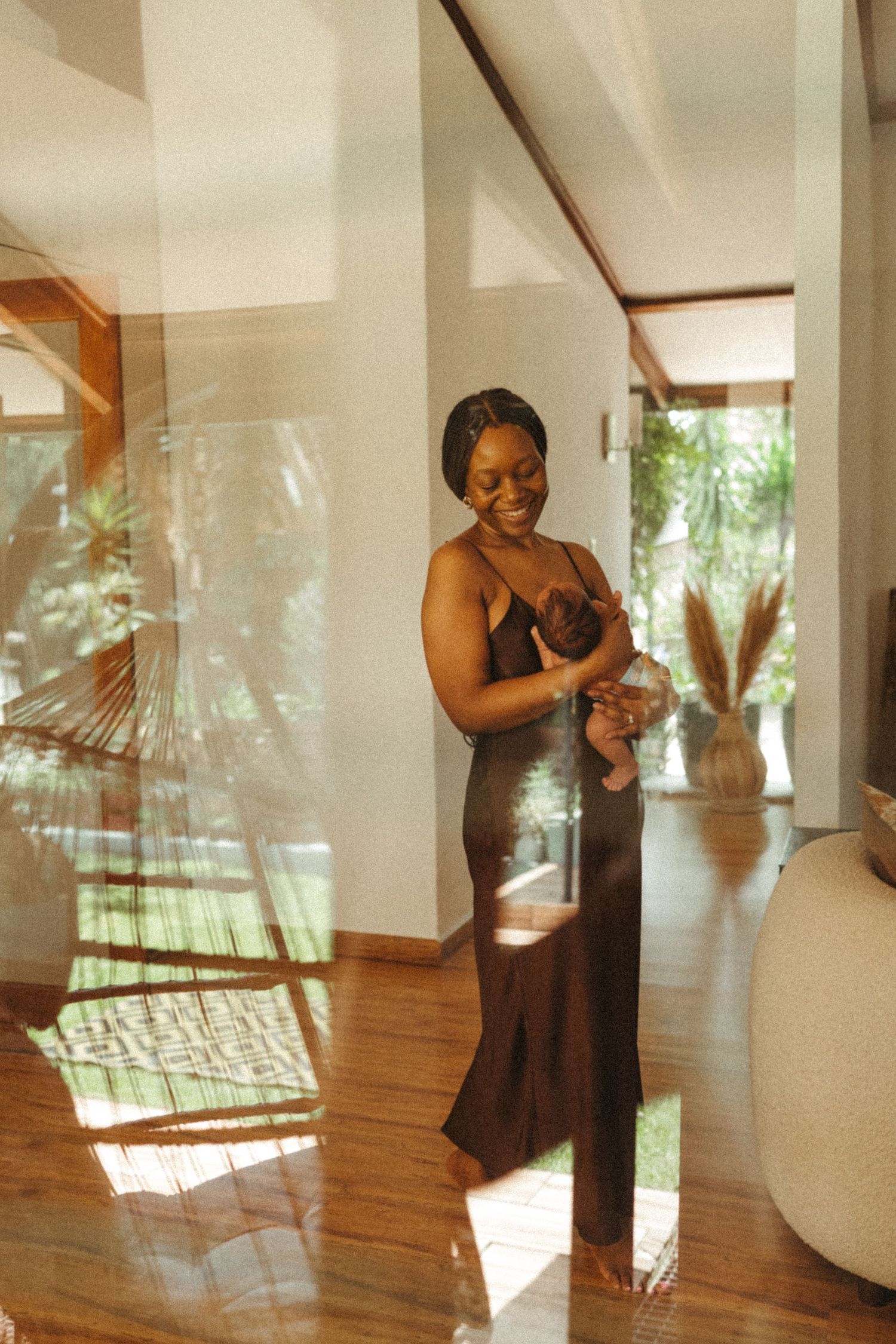 A series of photos showing a woman in a dark dress dancing in a sunlit room with hardwood floors.