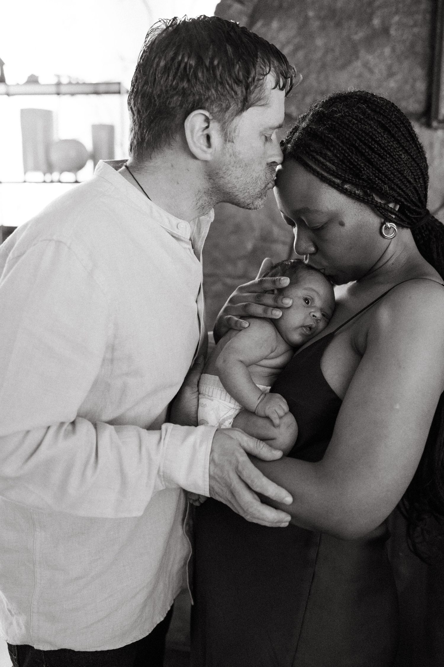 A tender sequence of black and white photos showing a couple in an emotional embrace.