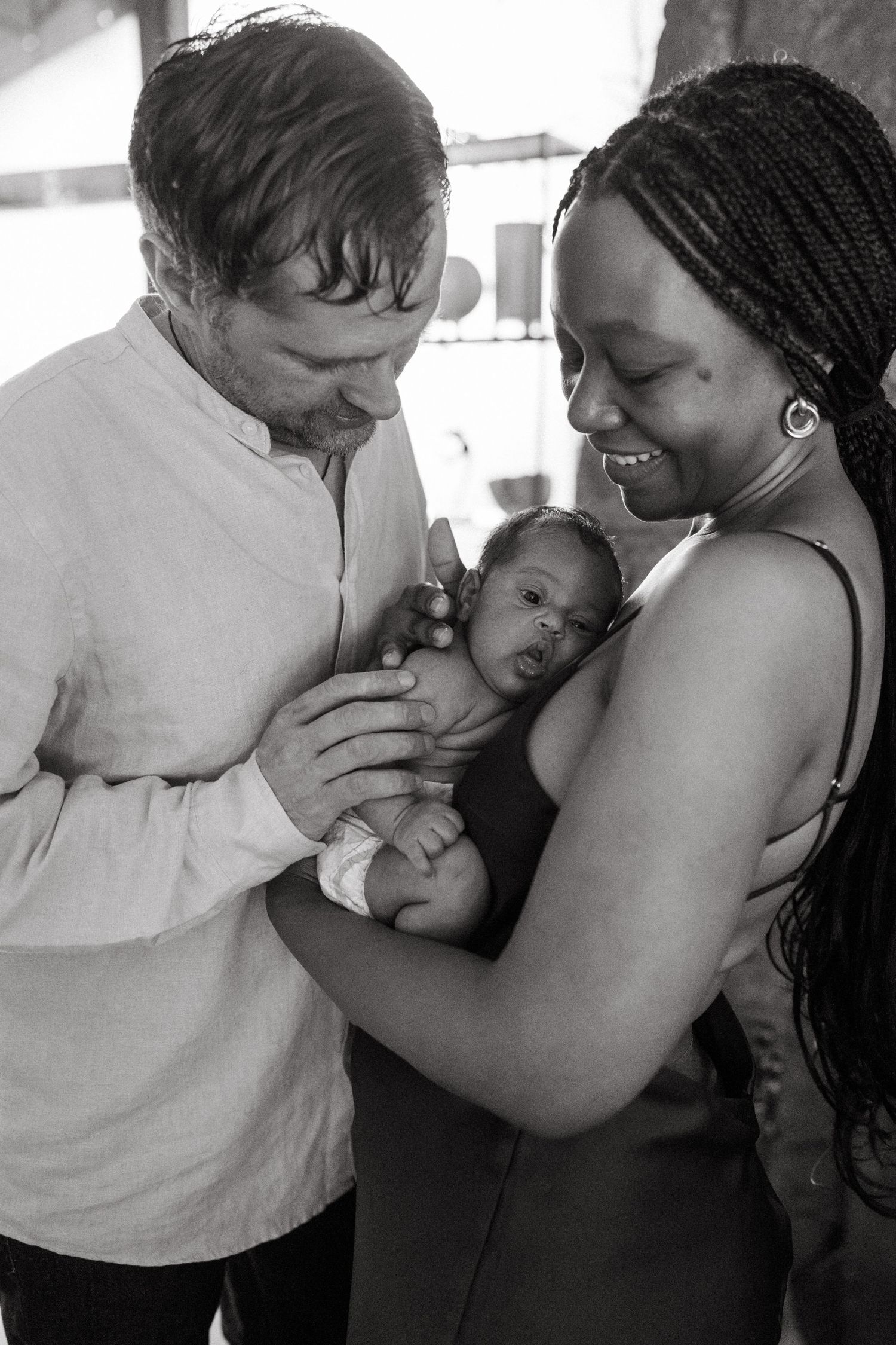 An intimate series of photos capturing tender moments between a couple and their newborn.