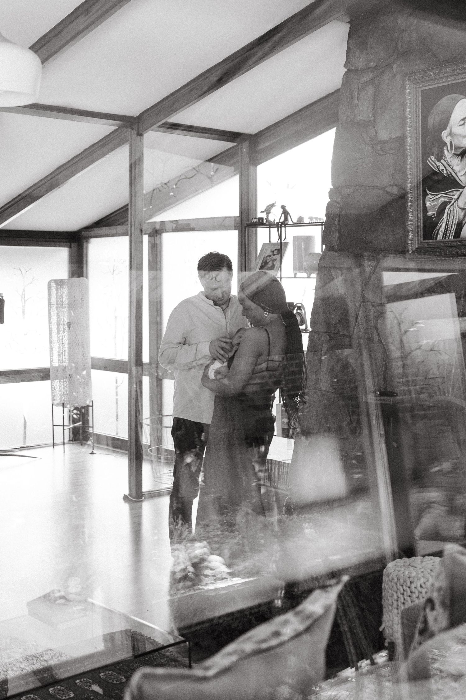 Multiple exposure photos of people moving through a modern interior space with large windows.