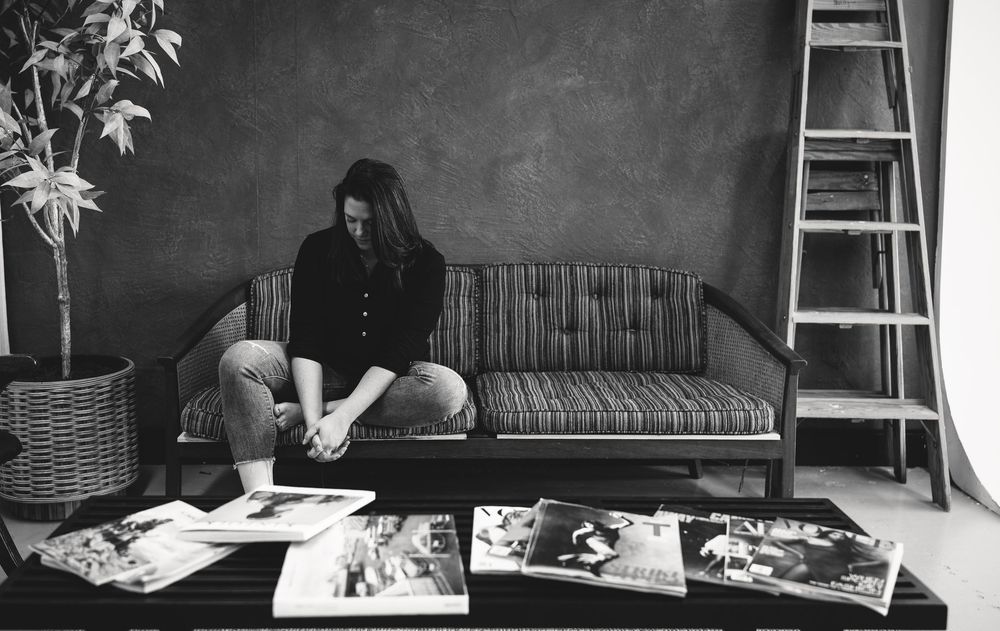 Black and white photo series showing a person lounging on a bed in various relaxed poses.