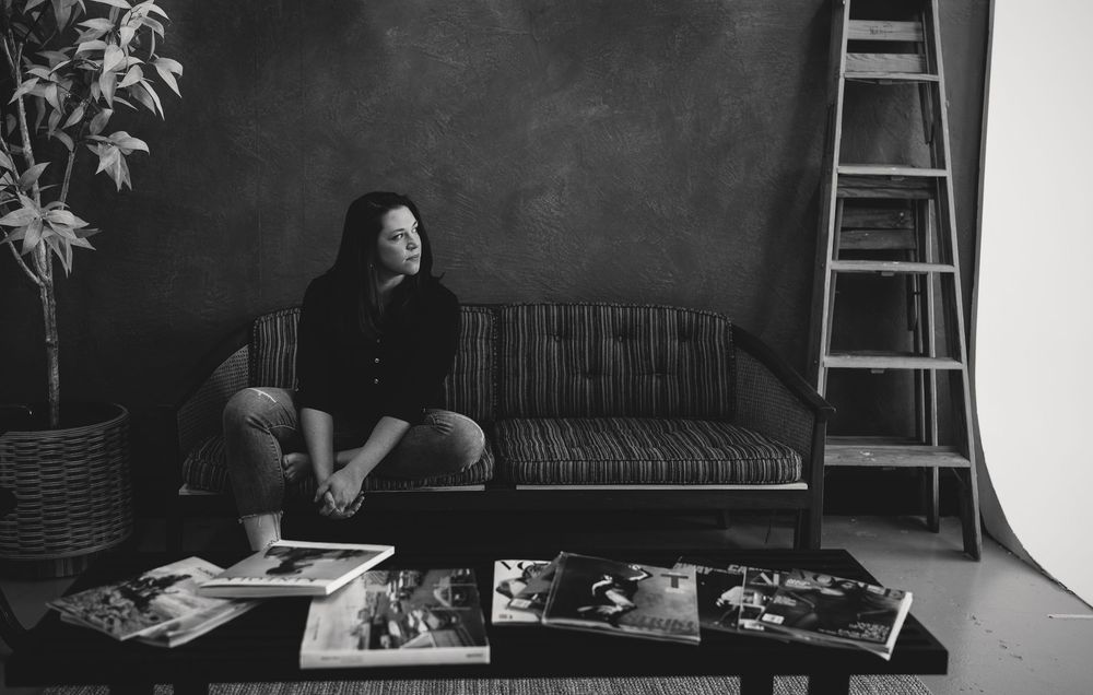 A black and white photo series showing a person reading and working at a desk in different positions and angles.