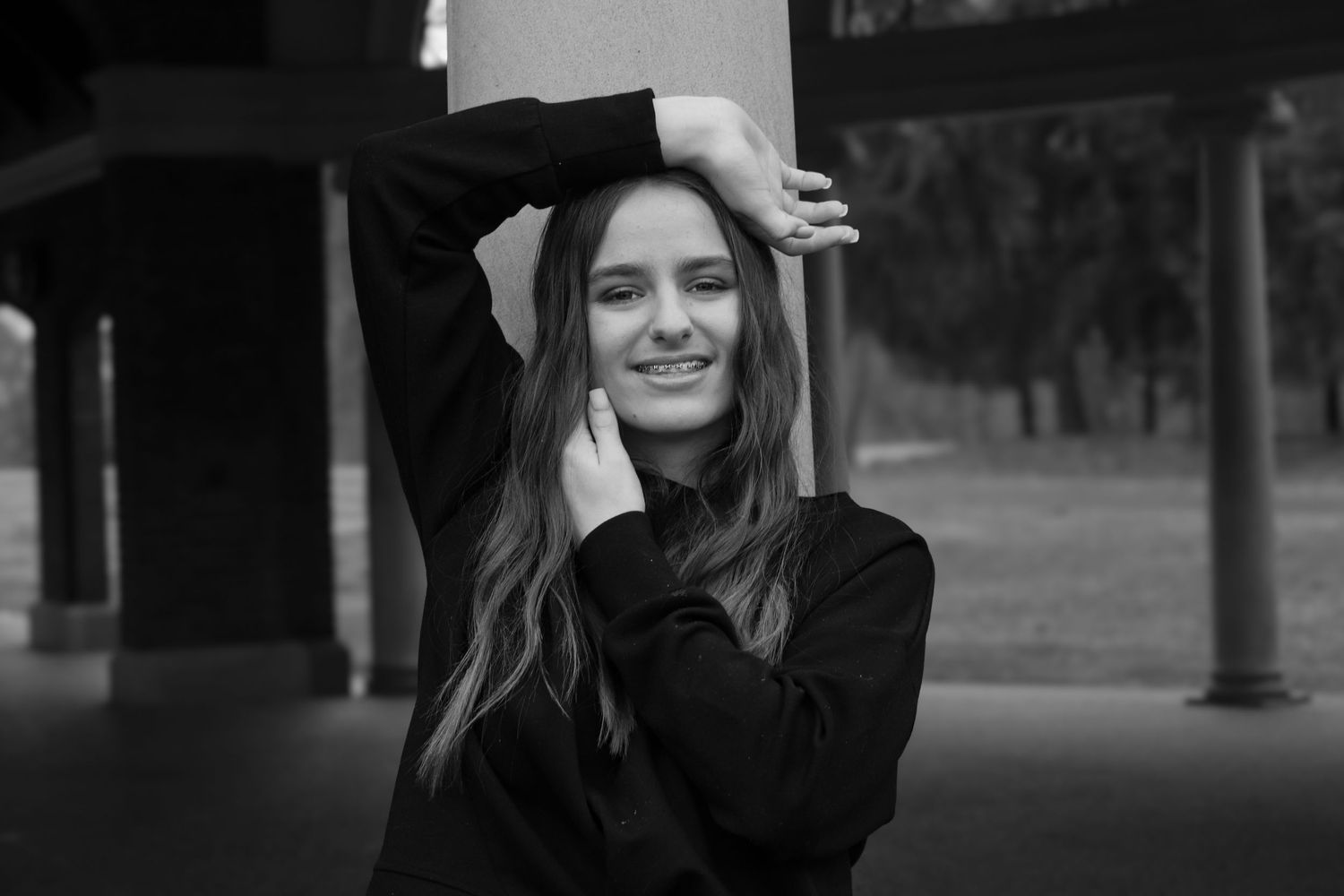 Black-and-white lifestyle portrait of a woman in natural light with a candid cinematic feel in Michigan